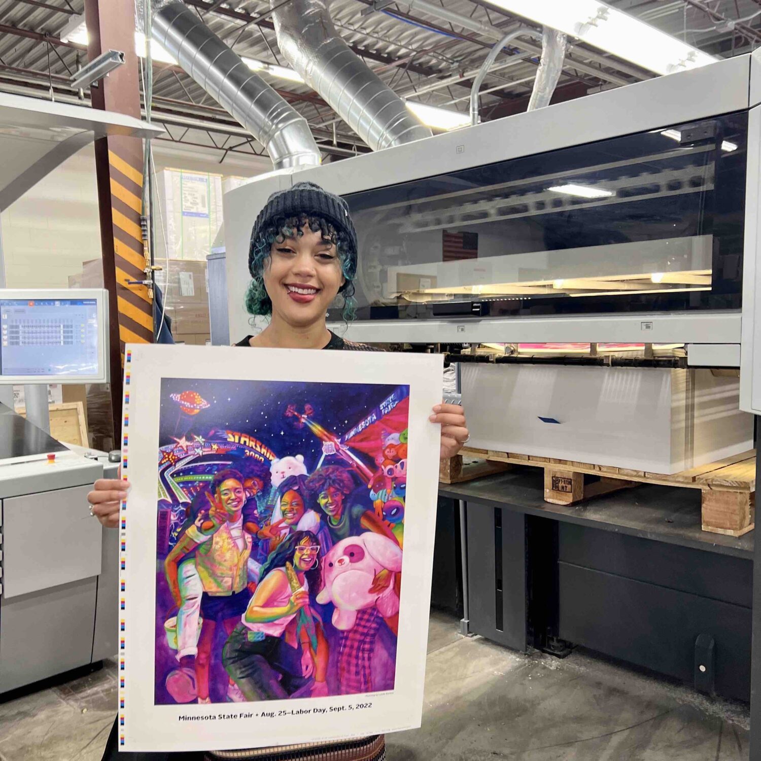Leslie Barlow with a newly printed poster of the 2022 Minnesota State Fair Official Commemorative Art